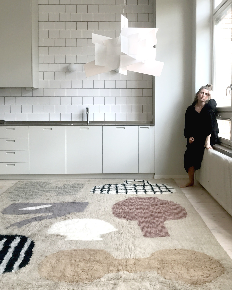 emilia ilke with her patterned rug for layered